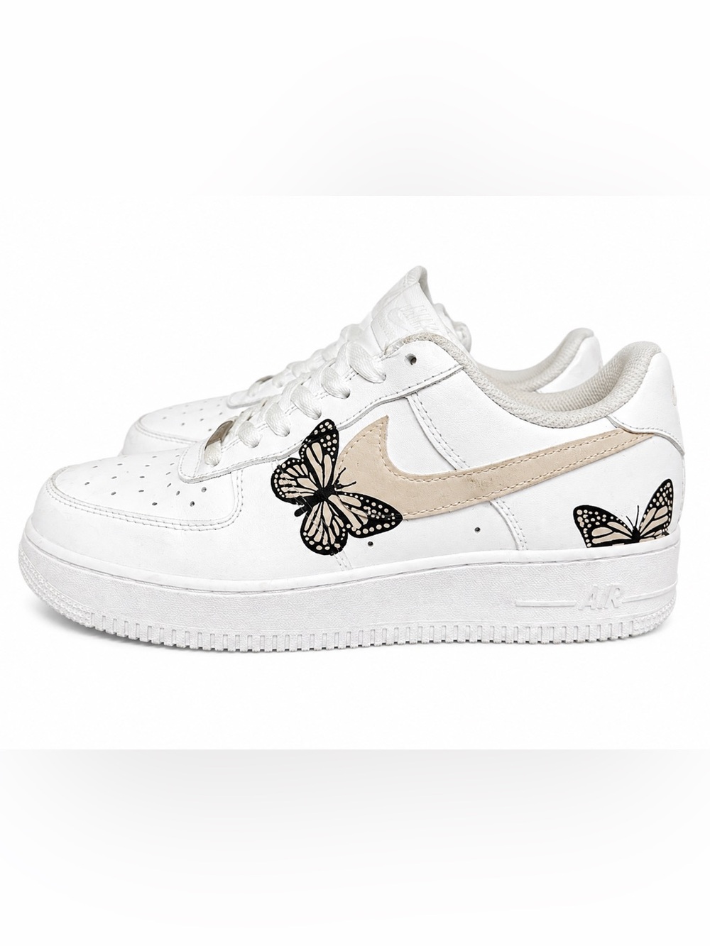 Nike Women’s White Low-Top Sneakers with Beige Swoosh and Black Butterfly